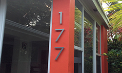 modern house numbers on orange post